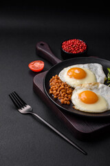 Delicious hearty breakfast consisting of two fried eggs, canned lentils and microgreens
