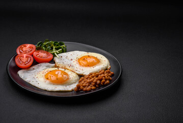 Delicious hearty breakfast consisting of two fried eggs, canned lentils and microgreens