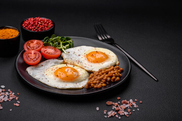 Delicious hearty breakfast consisting of two fried eggs, canned lentils and microgreens