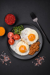 Fototapeta na wymiar Delicious hearty breakfast consisting of two fried eggs, canned lentils and microgreens