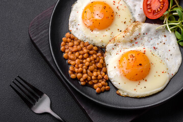 Delicious hearty breakfast consisting of two fried eggs, canned lentils and microgreens