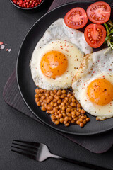Delicious hearty breakfast consisting of two fried eggs, canned lentils and microgreens