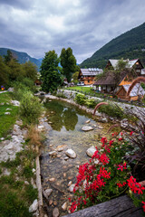 Beautiful wooden huts by the mountain river in Stara Fuzina village in Triglav National Park, Slovenia