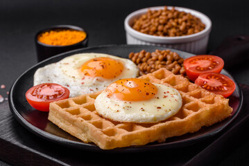 Delicious hearty breakfast consisting of a fried egg, Belgian waffle