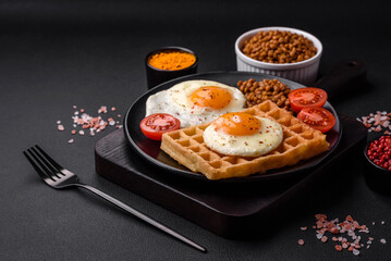 Delicious hearty breakfast consisting of a fried egg, Belgian waffle
