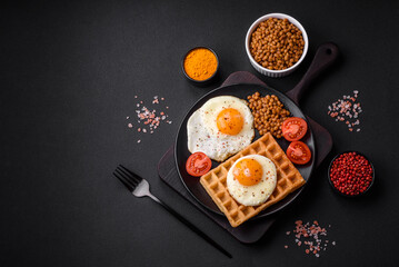 Delicious hearty breakfast consisting of a fried egg, Belgian waffle
