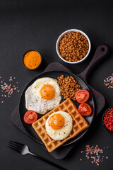 Delicious hearty breakfast consisting of a fried egg, Belgian waffle