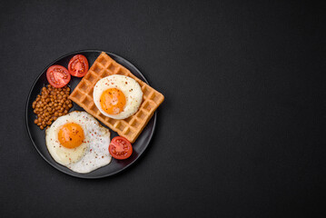 Delicious hearty breakfast consisting of a fried egg, Belgian waffle