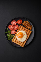 Delicious hearty breakfast consisting of a fried egg, Belgian waffle