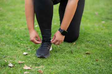 sport people adjusting shoelaces in black shoes