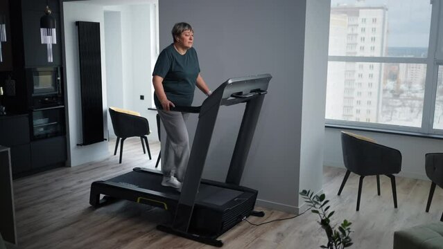 Aged Overweight Woman Training On Treadmill, Home Fitness For Senior People, Losing Weight