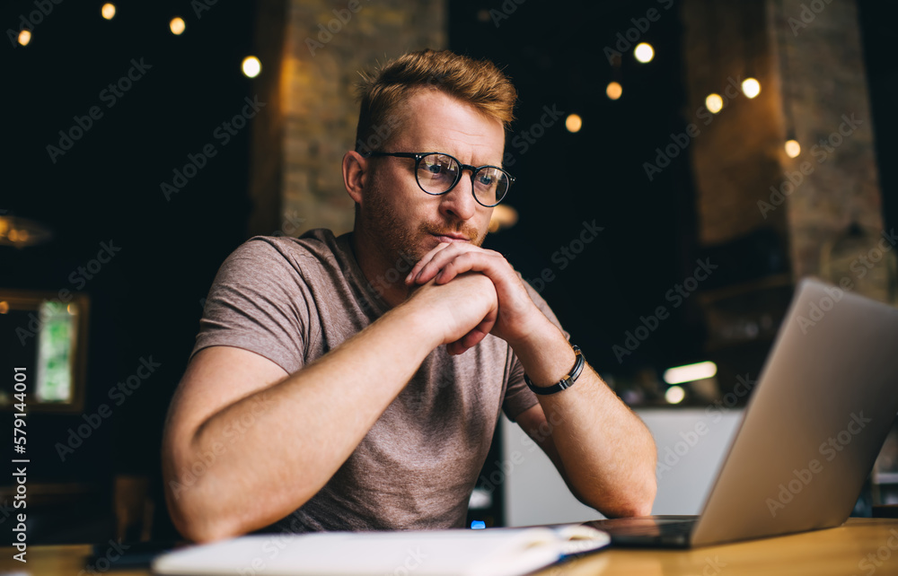 Poster caucasian blogger in optical eyewear watching education online webinar via application on digital ne
