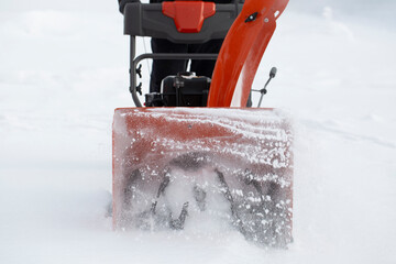 A portable snow blower powered by gasoline. Snow removal in winter.