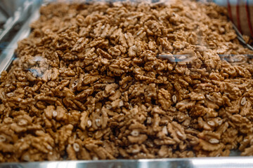 Heap of fresh raw walnut kernels in the market.