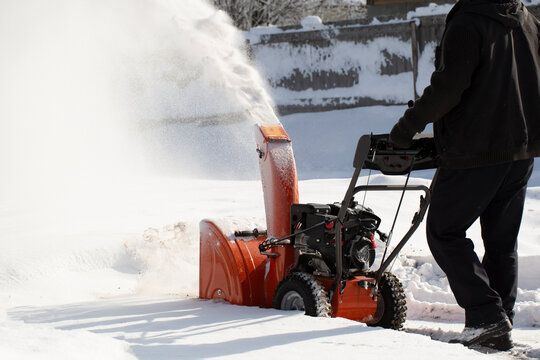 A portable snow blower powered by gasoline. Snow removal in winter.