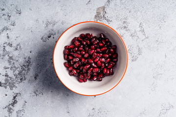 Bowl with pomegranate seeds,  preparing fruit salad, ingredient