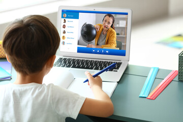 Little boy studying online at home