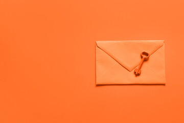 Envelope with key on orange background - obrazy, fototapety, plakaty