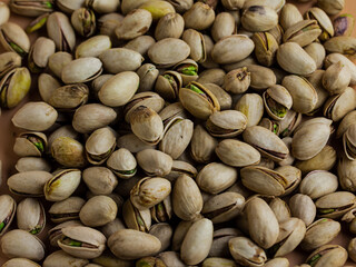 pistachio nuts in shell in a cream color background