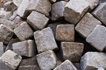 A pile of old large gray stone blocks.