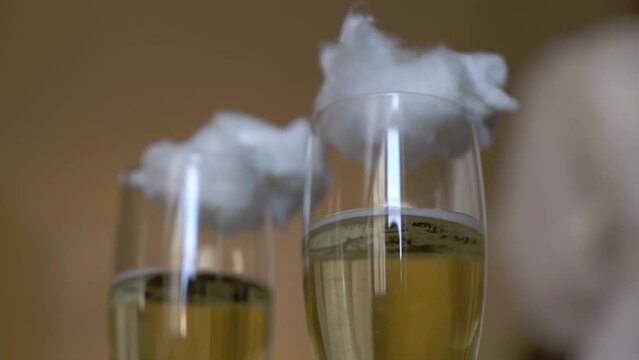 Two glasses of champagne. White sparkling wine and cotton candy. Romantic breakfast, dinner, vacation or date. Candyfloss.