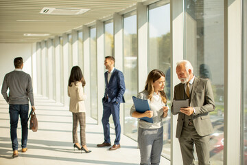 Obraz premium Modern business people using digital tablet in the office corridor