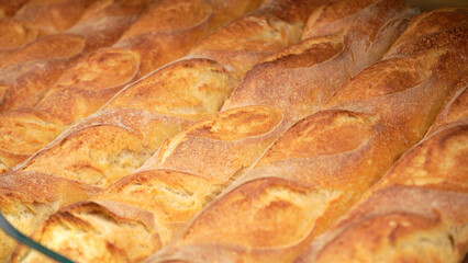 Fresh bread on the shelves of the bakery in the supermarket. Shopping at the grocery store. Selling food concept.