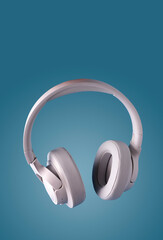 Fototapeta na wymiar white leather headphones on a blue background, copy space