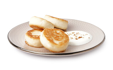 Plate with tasty cottage cheese pancakes and sour cream isolated on white background
