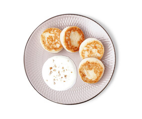 Plate with tasty cottage cheese pancakes and sour cream isolated on white background