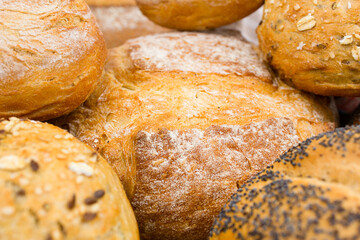 Various freshly baked bread close up. Texture of fresh baked goods.