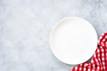 White plate and napkin at stone table. Table setting, Flat lay image.