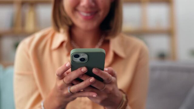 Woman, hands and phone on sofa for social media, chatting or texting in living room at home. Hand of happy female typing on smartphone for chat, browsing or mobile app on the lounge couch indoors