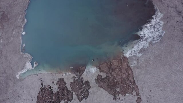 The blue lake in the crater of Gorely volcano. Kamchatka Peninsula, Russia