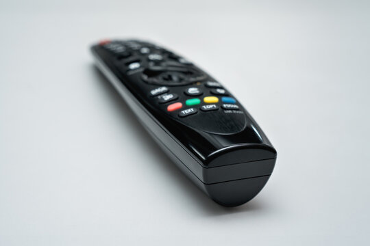 Black plastic tv remote control isolated on white background. Television watching and entertainment concept.