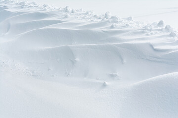 Abstract snow texture background. Close up snow dunes lines. Snowdrift nature background
