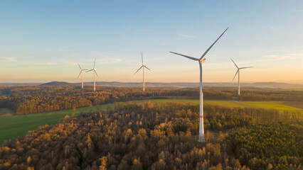 Aerial view of wind turbines in the countryside at sunset
