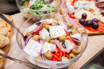 Colorful array of dishes, from salads to desserts and raw fruits and cheese, are beautifully...