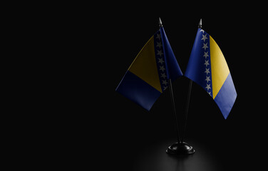 Small national flags of the Bosnia and Herzegovina on a black background