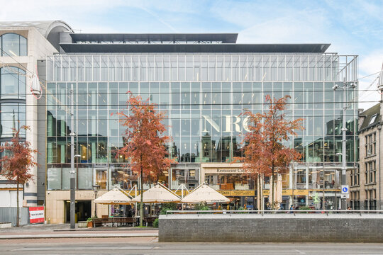 Amsterdam, Netherlands - 10 April, 2021: a city street with buildings and trees in the fore - image is taken from across the street to the other side