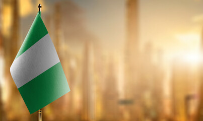 Small flags of the Nigeria on an abstract blurry background