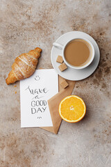 Morning cup of coffee, croissant, fresh orange and card 