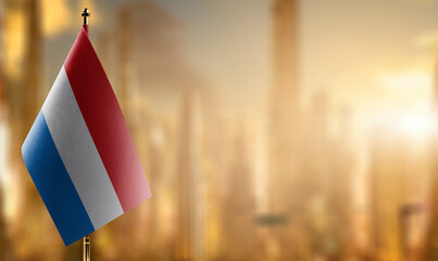 Fototapeta na wymiar A small Netherlands flag on an abstract blurry background