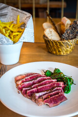 beef tenderloin with peppers and french fries