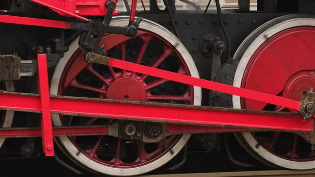 Tracking shot of wheels of the old style steam train locomotive