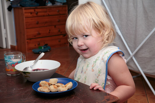 A little girl poses in front of the camera.