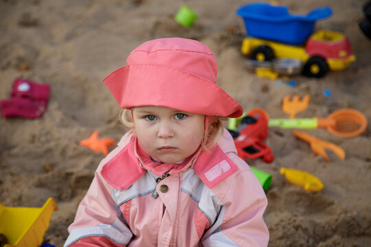 A little girl poses in front of the camera.
