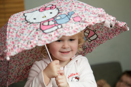 A little girl poses in front of the camera.