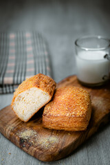 Bakery shop products - various kinds of baguette, bagel, donut, croissant, rolls, bread, puff pastry, powdered sugar delicious pies. Neutral background. Food from bakeries.