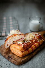 Bakery shop products - various kinds of baguette, bagel, donut, croissant, rolls, bread, puff pastry, powdered sugar delicious pies. Neutral background. Food from bakeries.